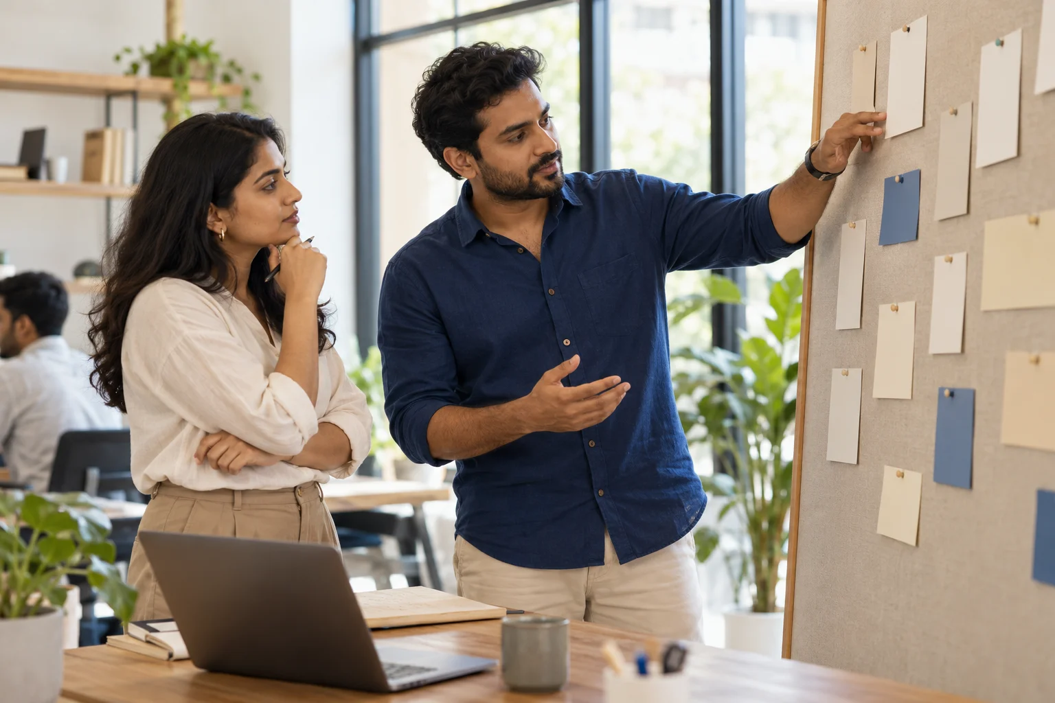 Illustrative scene: Founder and team lead reviewing a board of work cards.